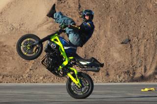 Freestyle motorcycle rider Nick Brocha performs in the parking lot of Sam Boyd Stadium during the Monster Energy Cup Saturday, Oct. 20, 2012.